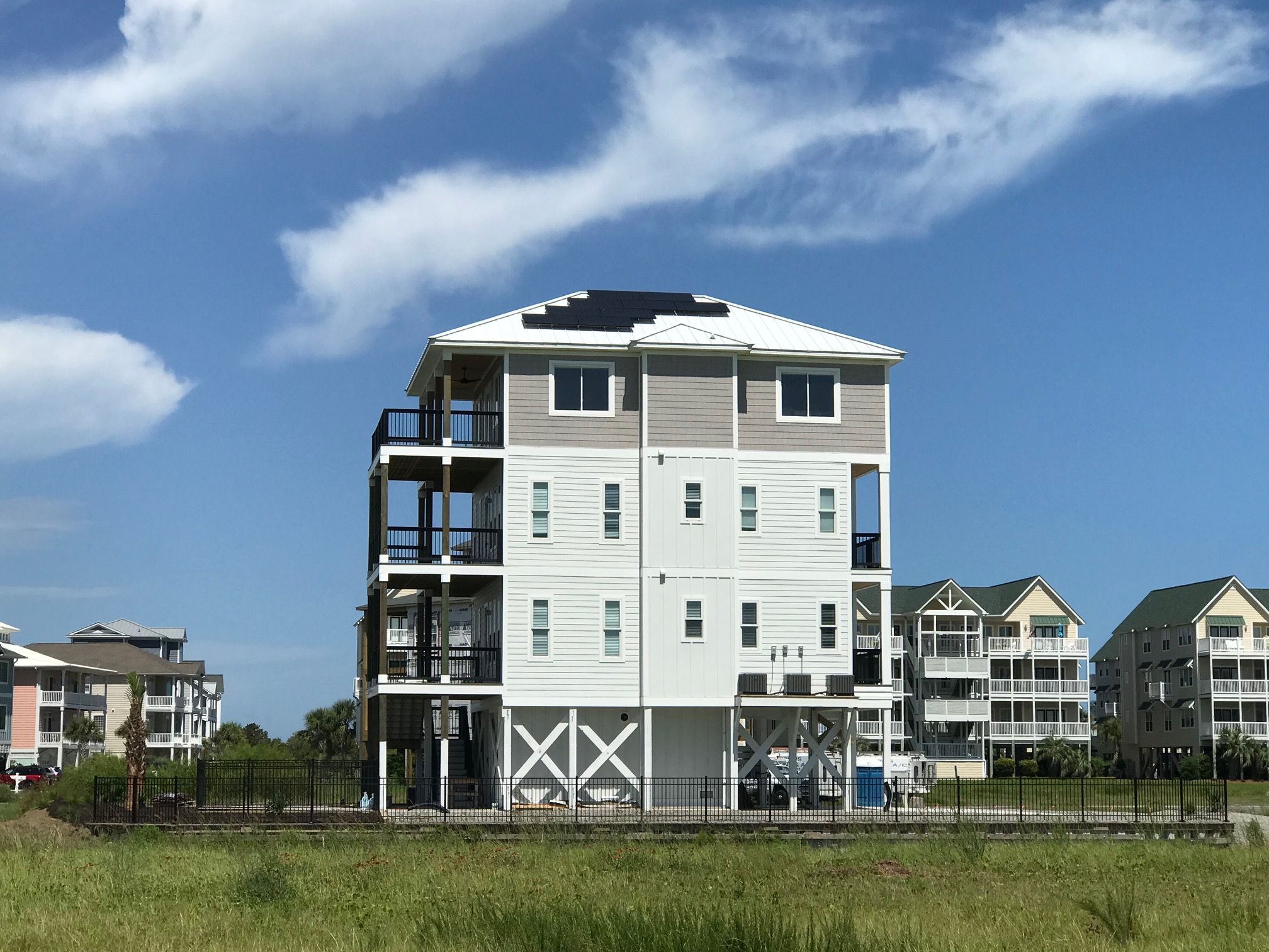 An elevated waterfront home built by Lackey Luxury Homes at Ocean Isle Beach.