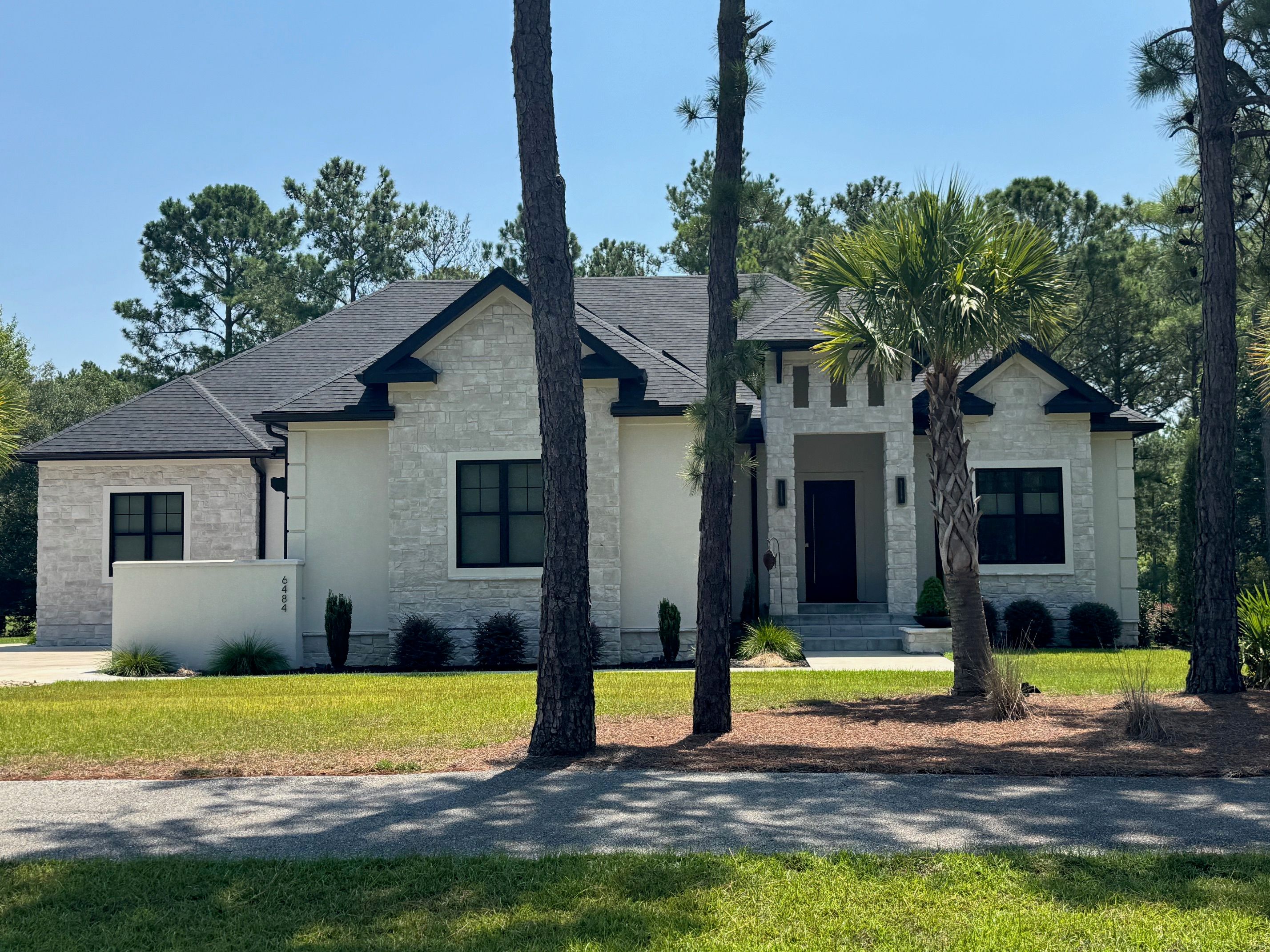 Clean lines, tall windows and a low profile under the pines.