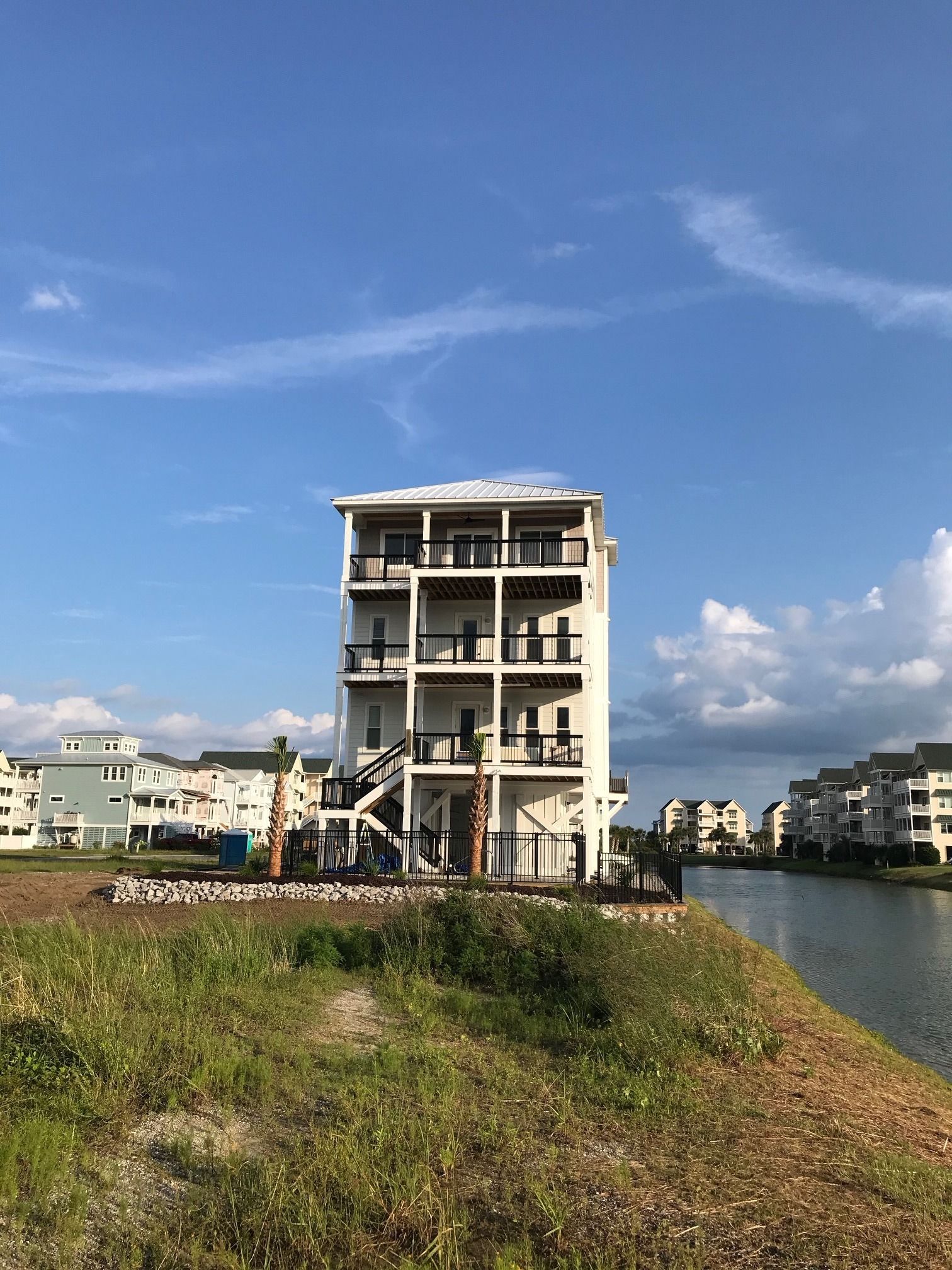 A four-storey elevated home on the water, built for salt air, storm season and a view from every floor.